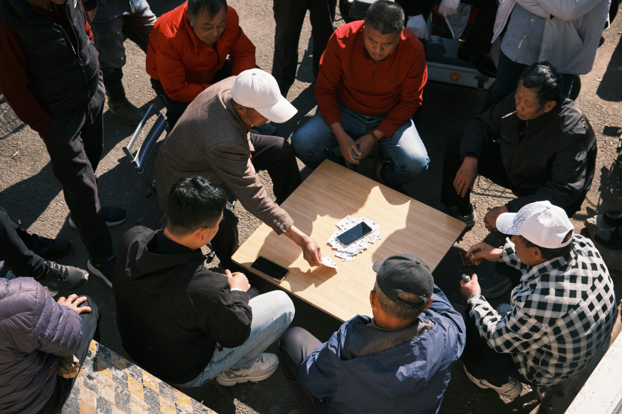 A group of people laughing and playing games on a large tablet