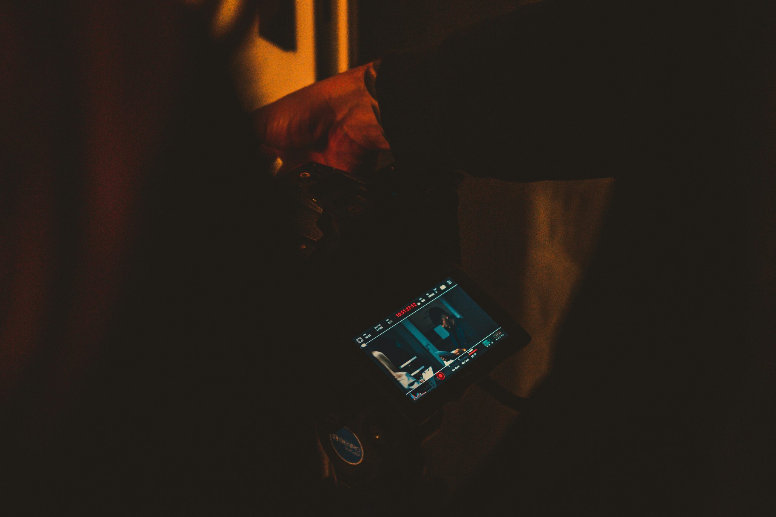 A person holding a tablet while playing a rhythm game