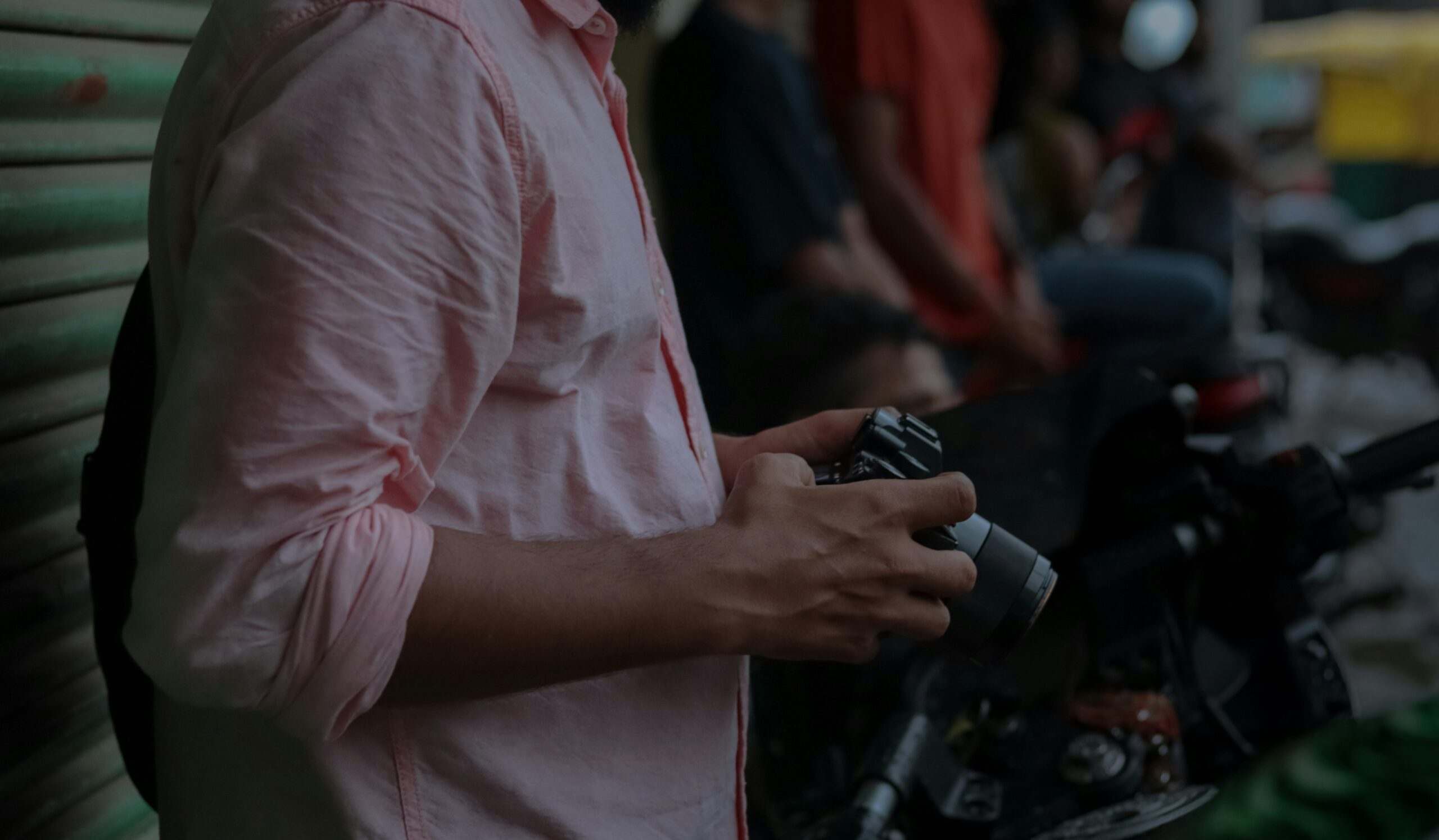 Gamer intently focused on their tablet with a controller attached.