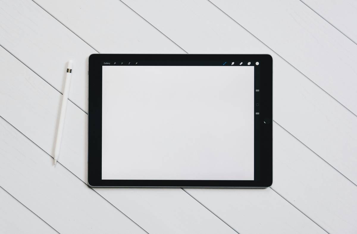 A sleek tablet being used for digital art with a stylus.
