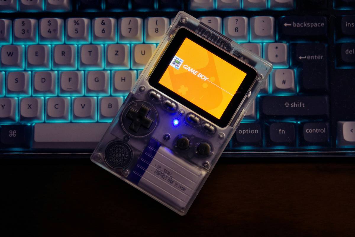 Photo of professional gamer using a tablet and controller setup