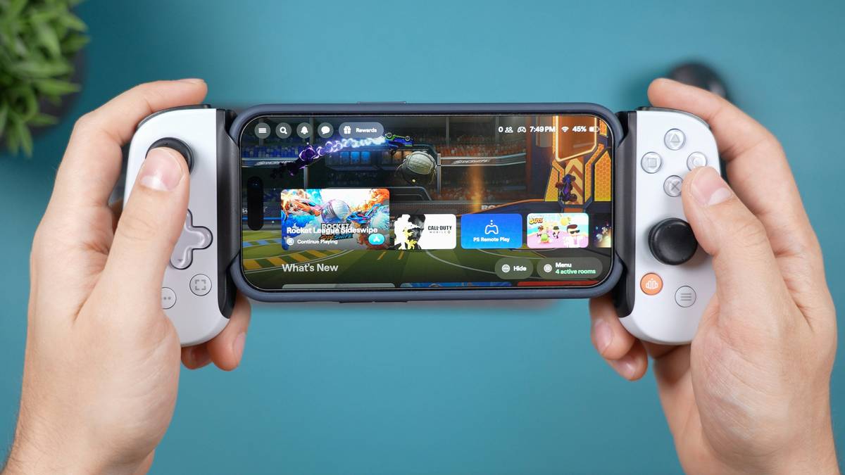 Happy gamer holding a tablet with a glowing controller icon