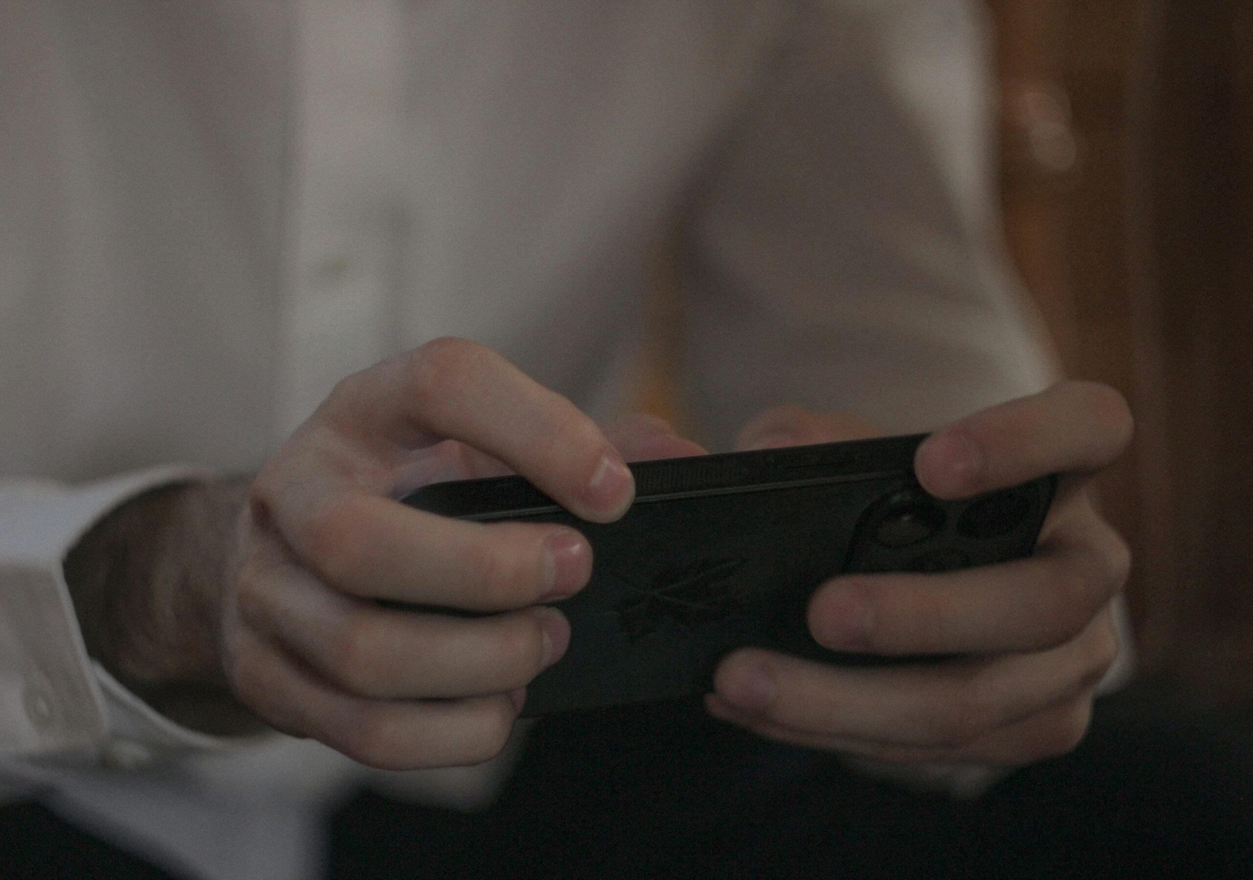 A person is holding and using a smartphone.