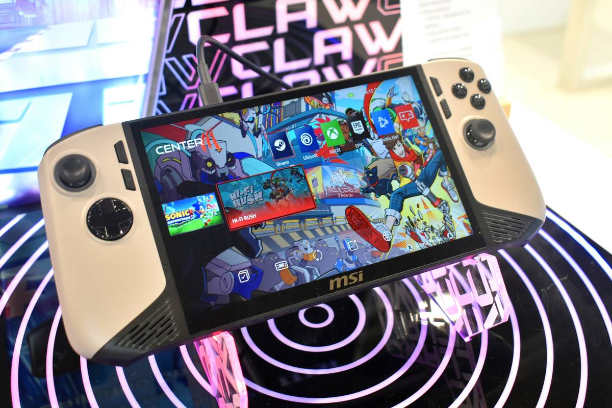 A gamer holding a tablet connected to a controller via USB-C